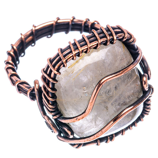 Oxidized copper wire-wrap ring showing bezel and clear quartz centerpiece.