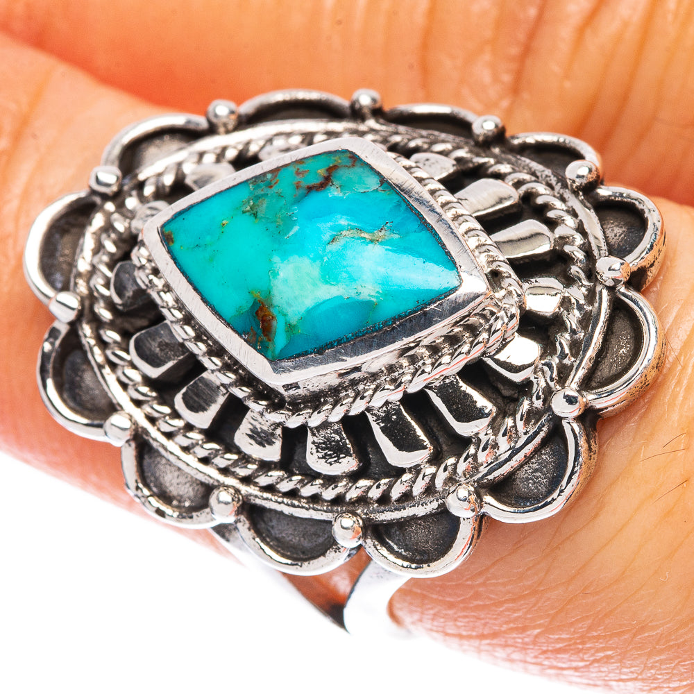Sterling silver ring with turquoise blue diamond-shaped center stone, ornate braided setting