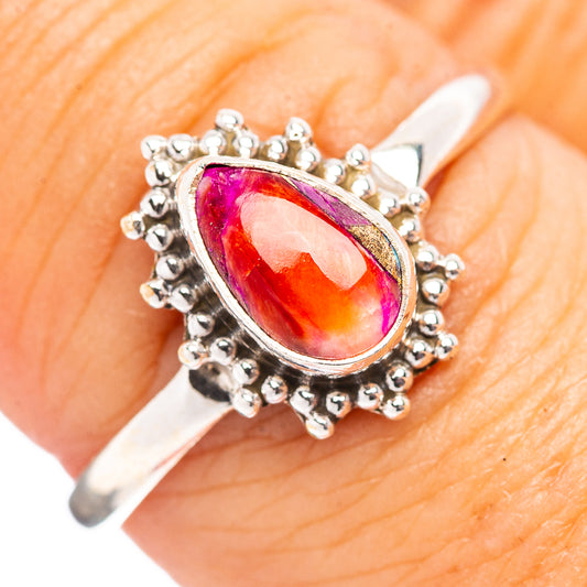 Oval gemstone ring in .925 sterling silver with pink-orange-red center and beaded halo