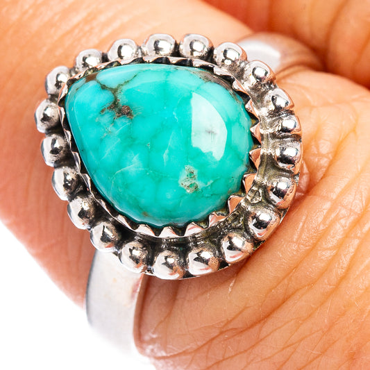 Turquoise gemstone ring with oval cabochon and sterling silver beaded bezel on top