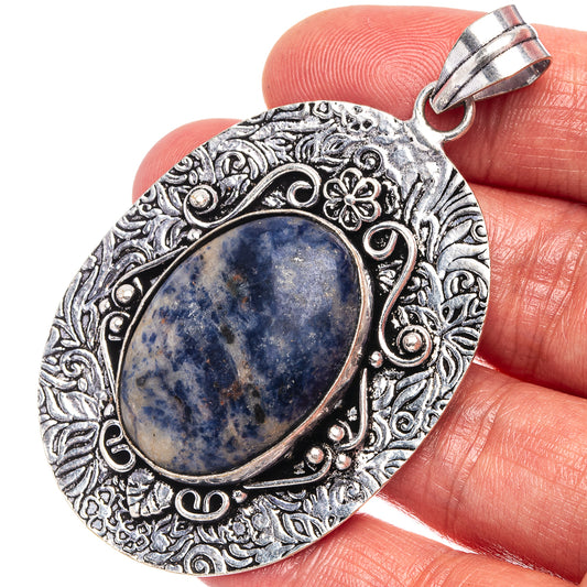 German silver teardrop pendant with blue sodalite cabochon and ornate filigree border