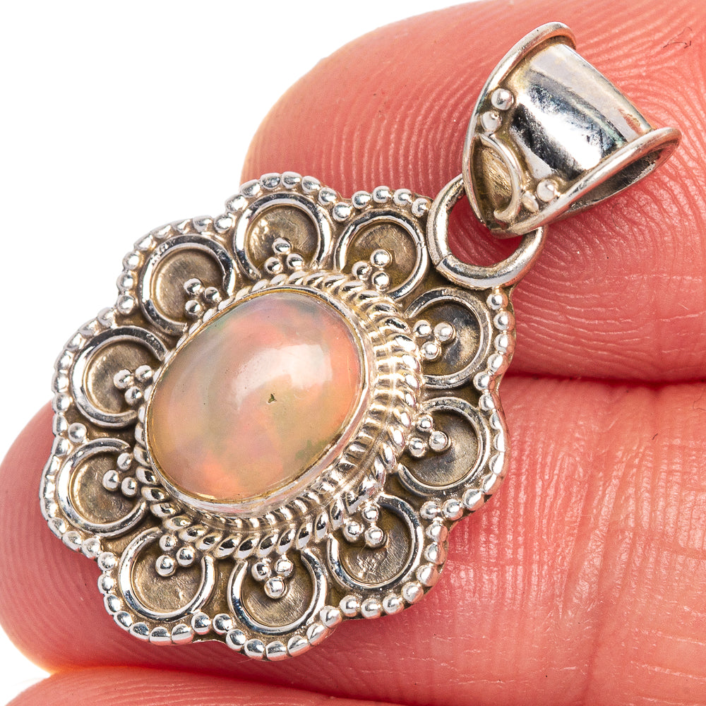 Ethiopian oval opal pendant with ornate sterling silver filigree, close-up on stone