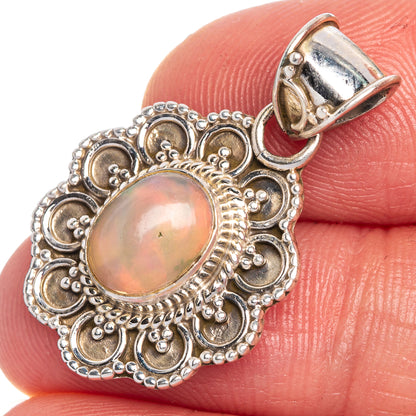 Ethiopian oval opal pendant with ornate sterling silver filigree, close-up on stone