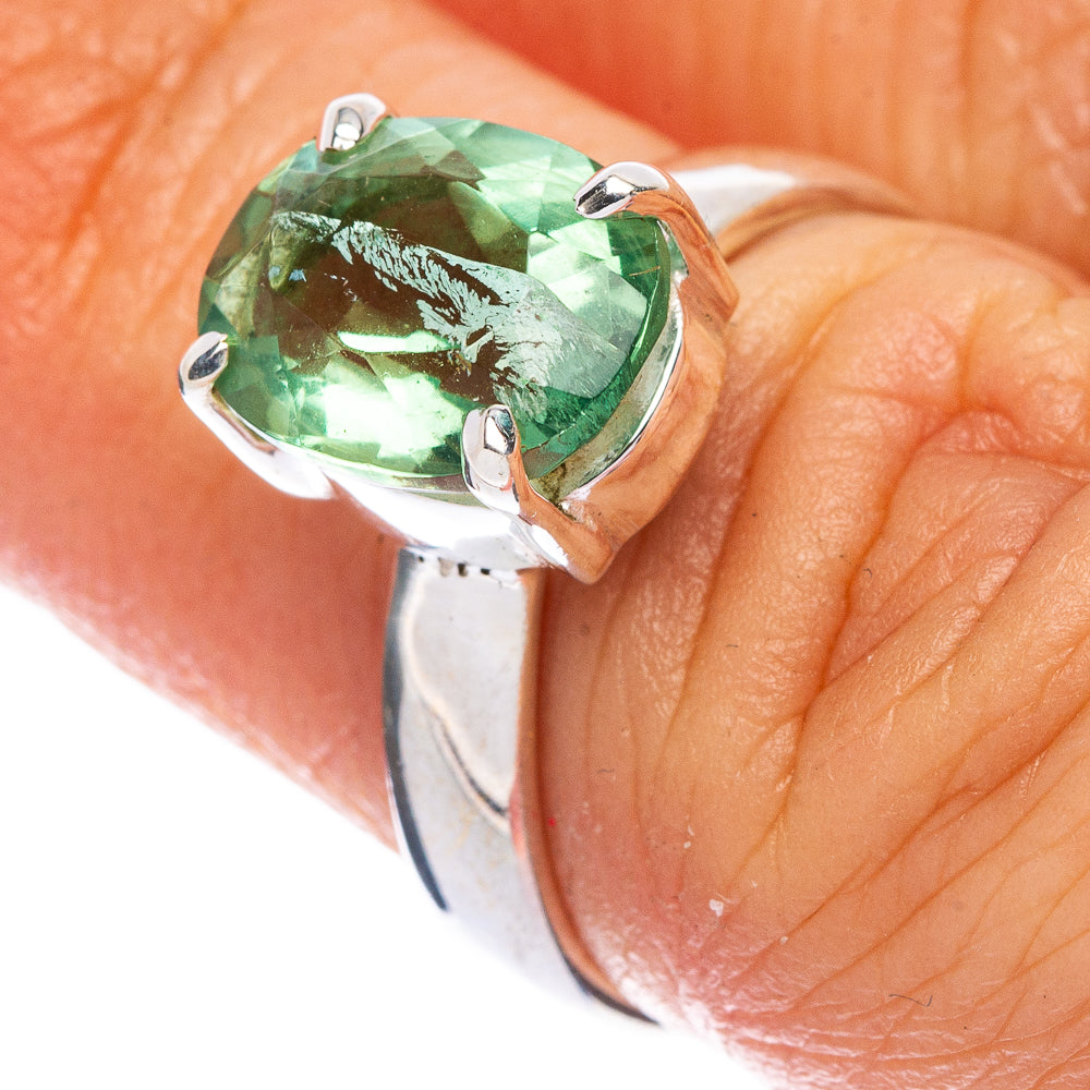 Oval green apatite gemstone ring in 925 sterling silver bezel on finger