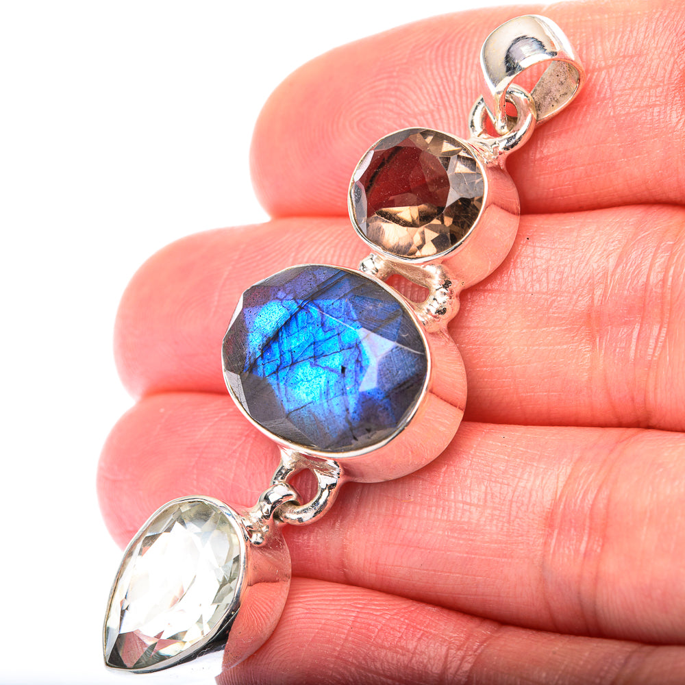 Sterling silver gemstone pendant with blue round labradorite, reddish-brown stone and clear stone