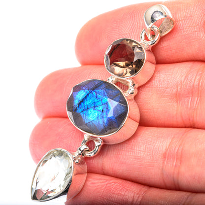 Sterling silver gemstone pendant with blue round labradorite, reddish-brown stone and clear stone