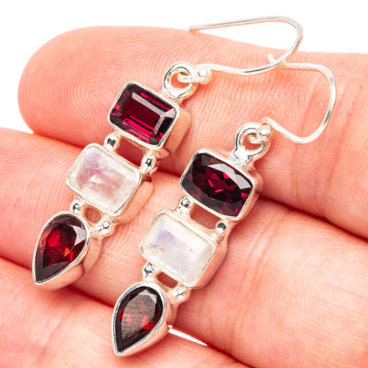 Sterling silver drop earrings with red gemstones and clear square accents