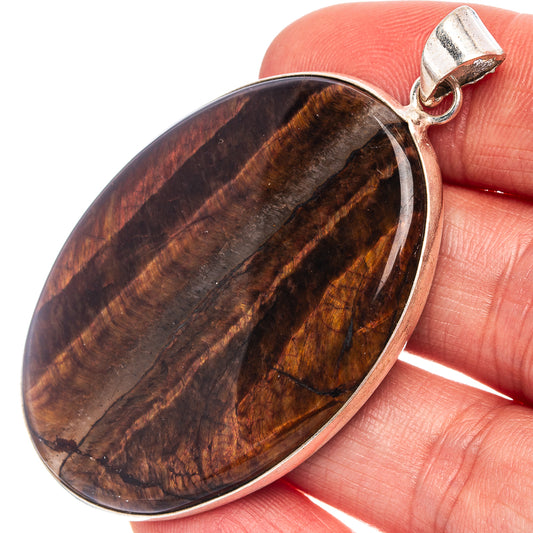 Silver-plated oval tiger's eye pendant with brown-gold striped stone bezel