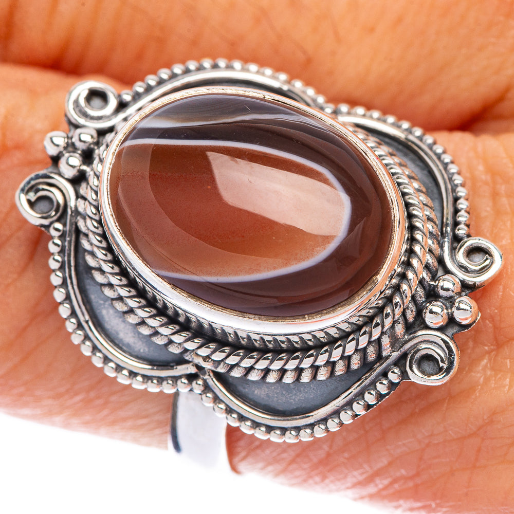 Sterling silver ring with oval brown Botswana agate and ornate rope bezel setting