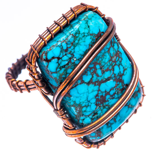Oval turquoise stone ring with oxidized copper wire framework and raised bezel