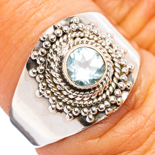 Sterling silver ring with light blue gemstone and bead-textured halo setting
