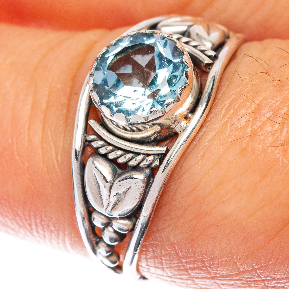 Sterling silver ring with oval blue topaz gemstone in ornate setting