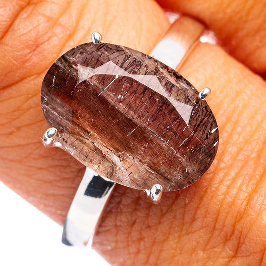 Sterling silver ring with oval dark red rutilated gemstone and four-prong setting