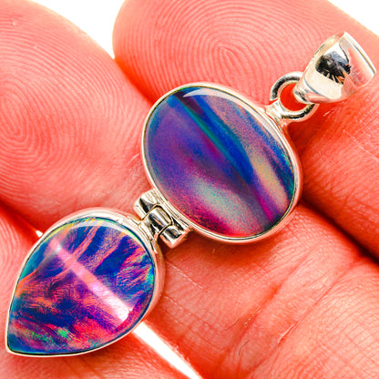 Sterling silver opal pendant with two iridescent teardrop cabochons, close-up
