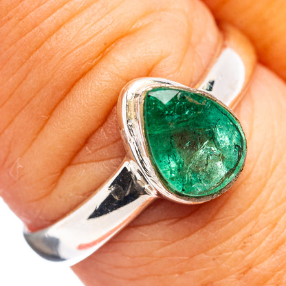 Sterling silver emerald ring with teardrop green gemstone, close-up on finger