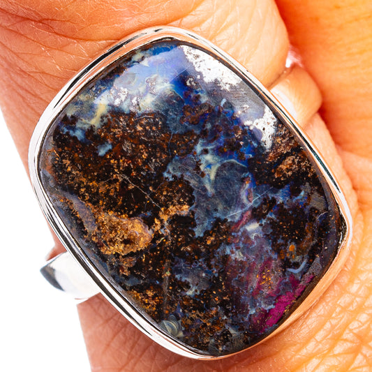 Sterling silver ring with oval boulder opal cabochon, blue-black with gold flecks