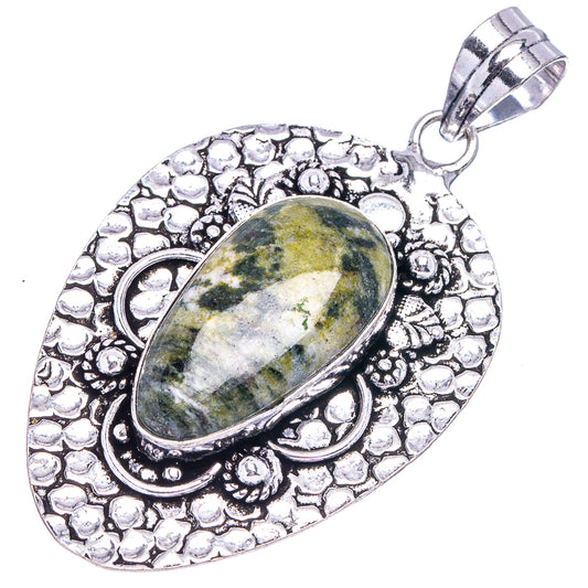 German silver oval pendant with green-gray stone, textured border and loop bail