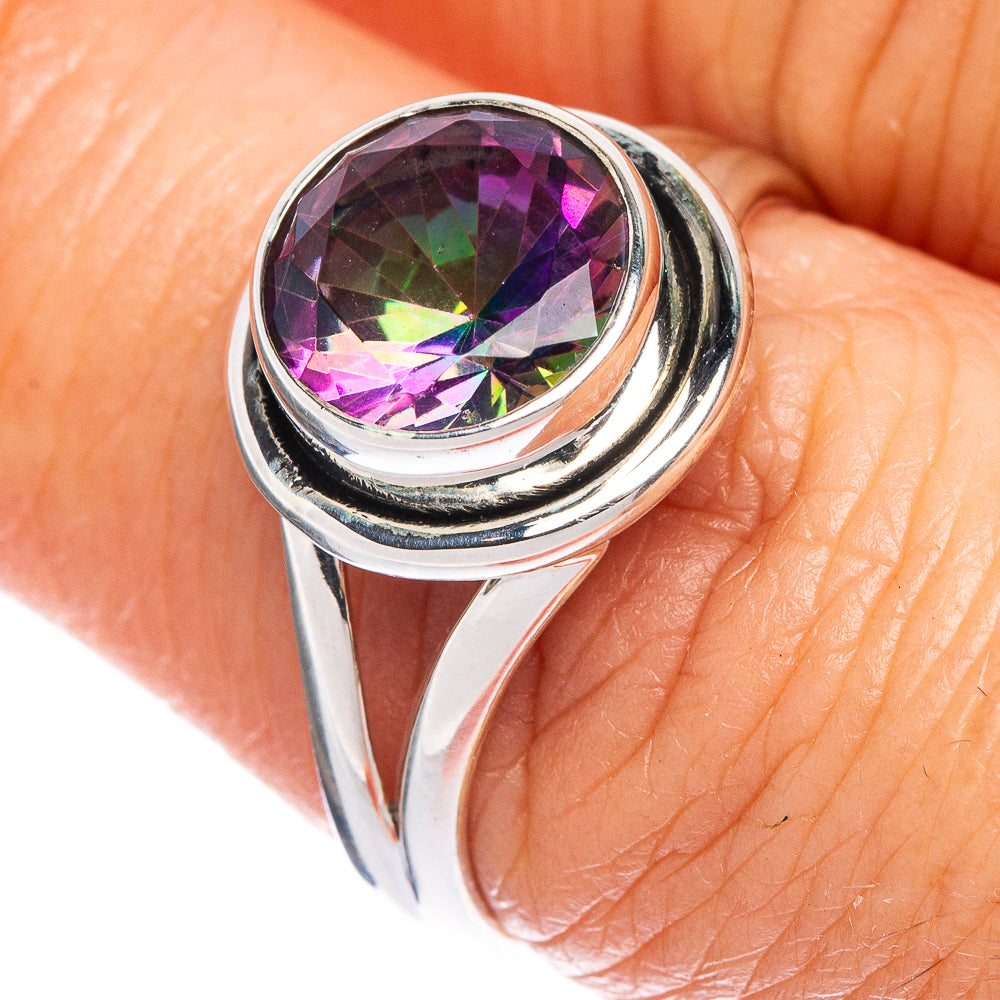 Sterling silver ring with prong-set multicolor gemstone, close-up on finger