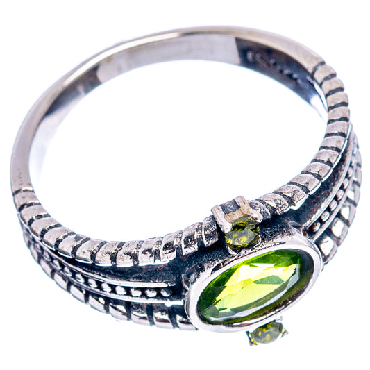 Sterling silver peridot ring with textured band and oval green center stone, side view