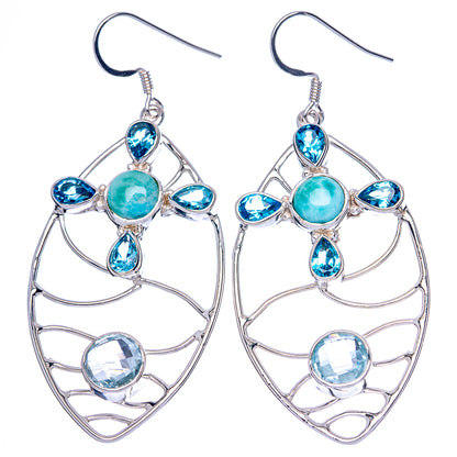 Pair of sterling silver drop earrings with teal center stone and blue accent gemstones