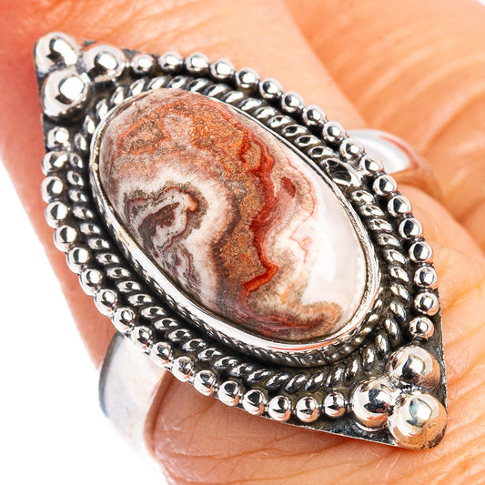 Oval crazy lace agate ring in sterling silver, red-and-white stone with bead border.
