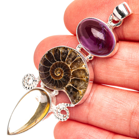 Sterling silver ammonite fossil pendant with purple cabochon and gold teardrop