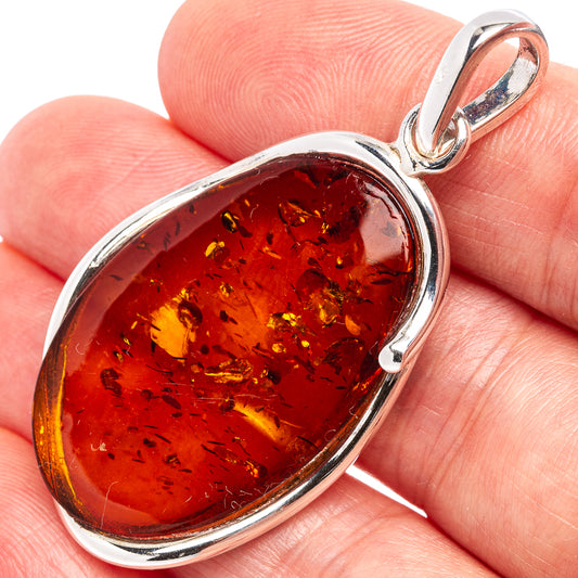 Oval amber pendant with .925 sterling silver bezel and loop bail