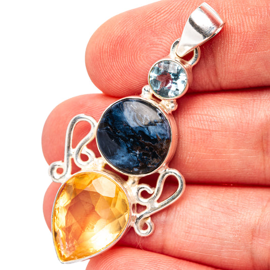 Sterling silver gemstone pendant with blue center and yellow drop, small light-blue stone