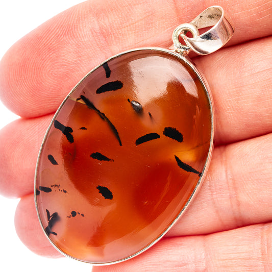 Oval amber agate pendant with black inclusions, .925 sterling silver bezel and bail