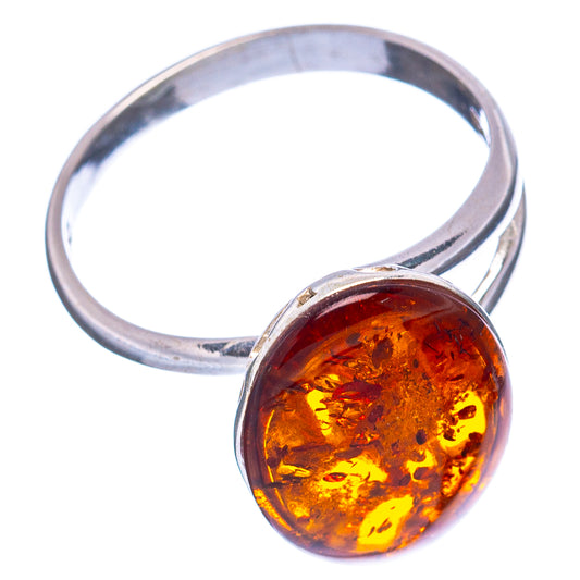 Adjustable sterling silver ring with oval amber-orange Baltic amber cabochon stone