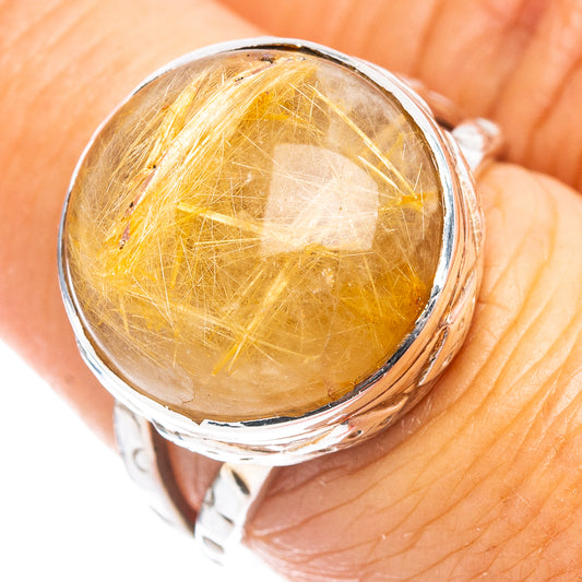 Sterling silver rutilated quartz ring with oval gold rutile gemstone, close-up bezel