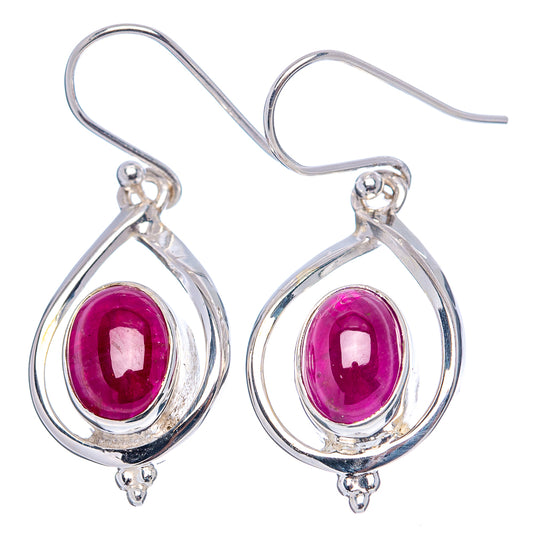 Sterling silver ruby drop earrings with faceted oval purple-red stones in teardrop frames