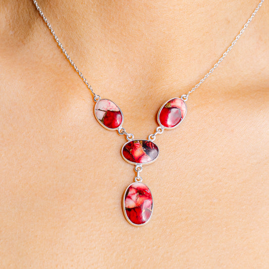 Sterling silver necklace with four oval pink-red gemstone pendants