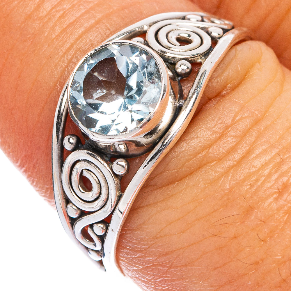 Sterling silver dainty ring with round blue gemstone, swirl settings