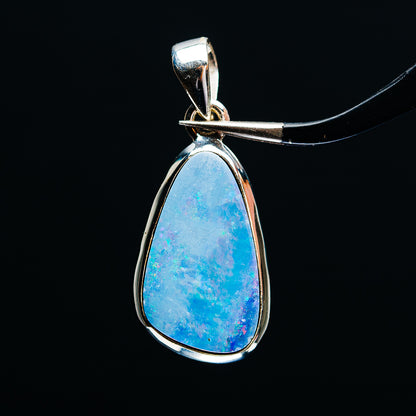 Sterling silver teardrop fire opal pendant with blue stone and loop bail