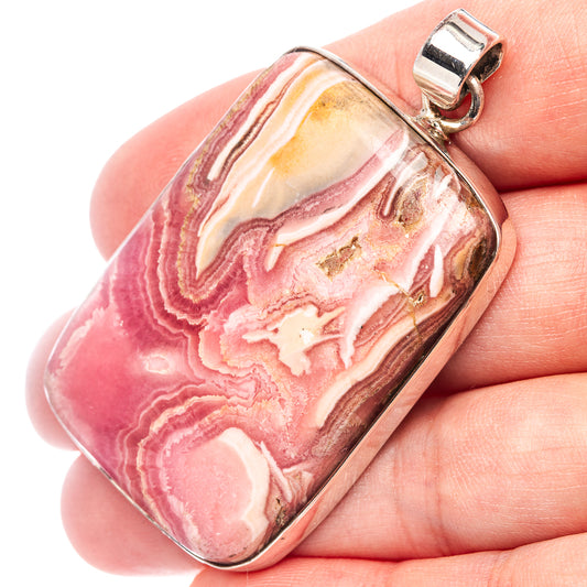 Rhodochrosite pendant in silver with pink-and-cream stone, rectangular bezel and loop bail
