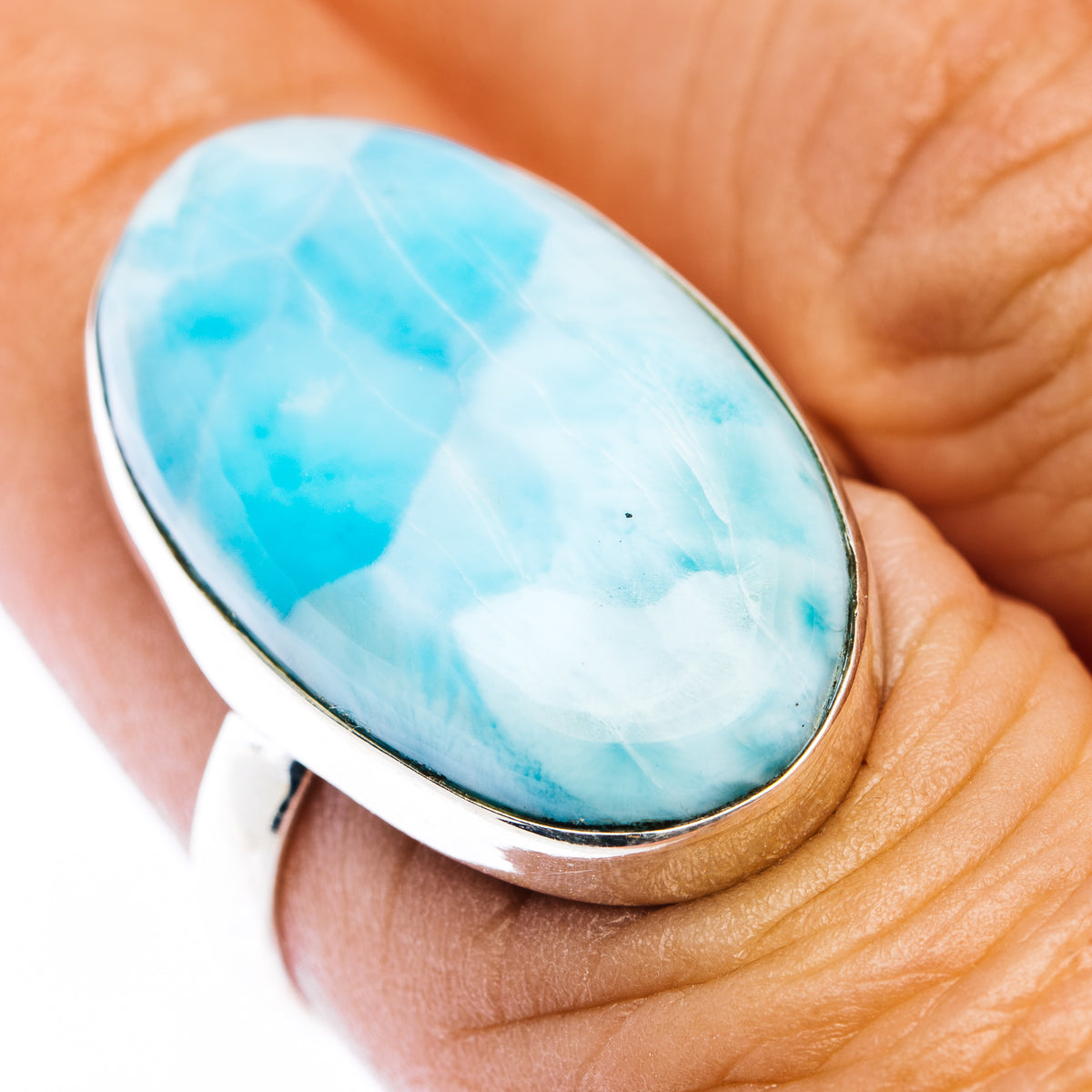 Oval larimar cabochon ring with sterling silver bezel and sky-blue stone