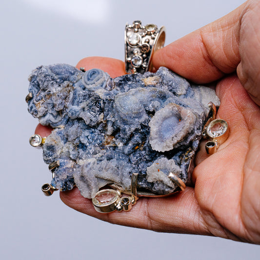 Blue druzy crystal cluster pendant with .925 sterling silver bezel and round side stones