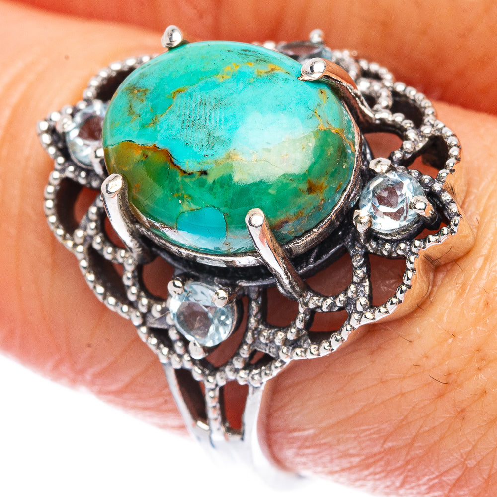 Oval turquoise cabochon sterling silver ring with ornate openwork and small clear stones