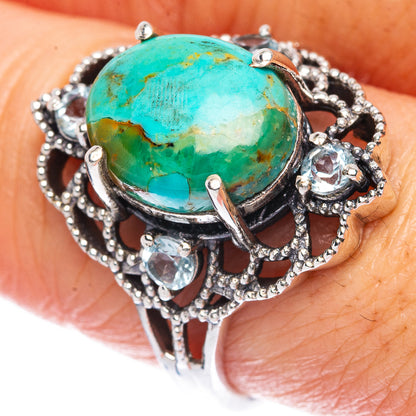 Oval turquoise cabochon sterling silver ring with ornate openwork and small clear stones
