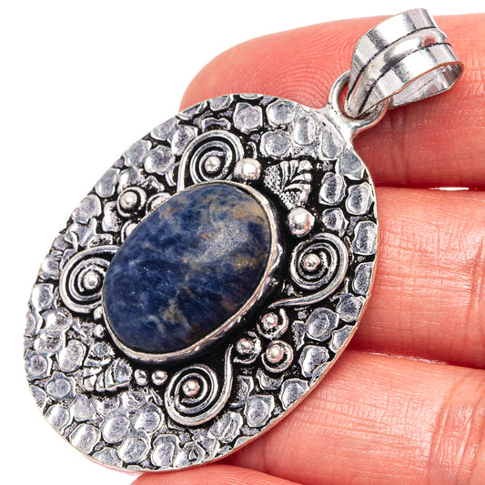 German silver sodalite oval pendant with ornate scrollwork and top loop bail