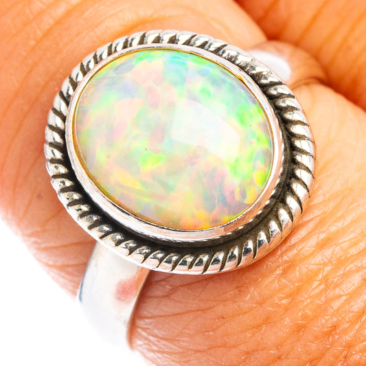 Round opal cabochon ring in sterling silver with rope-textured border, close-up