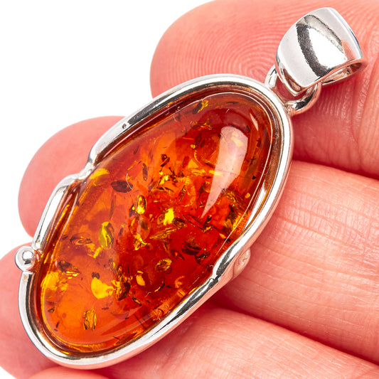 Oval amber pendant in .925 sterling silver bezel with warm orange Baltic amber cabochon.
