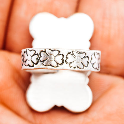 Sterling silver ring band with engraved four-leaf flower pattern
