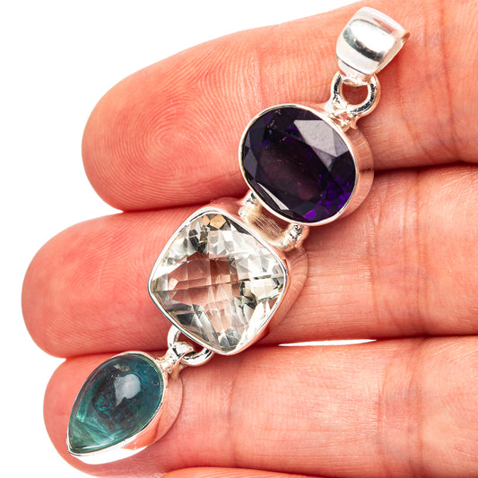 Sterling silver pendant with faceted amethyst, clear stone, and green cabochon