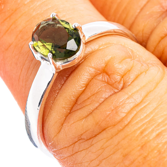 Sterling silver ring with oval faceted green moldavite gemstone on top