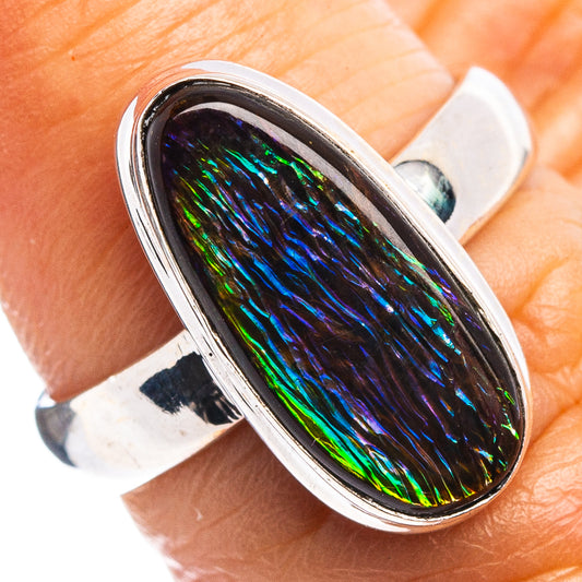 Sterling silver ammolite ring close-up, oval iridescent rainbow stone in bezel