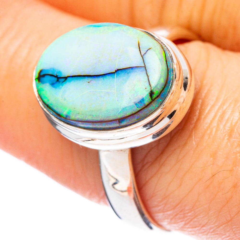 Oval light-blue opal cabochon set in polished 925 sterling silver ring with prong bezel