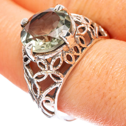 Silver filigree ring with faceted green amethyst gemstone, openwork band