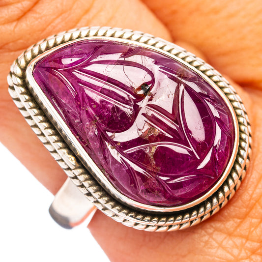 Carved ruby ring with teardrop-shaped purple-red stone in braided silver setting